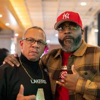 Two event attendees standing together and posing for photo